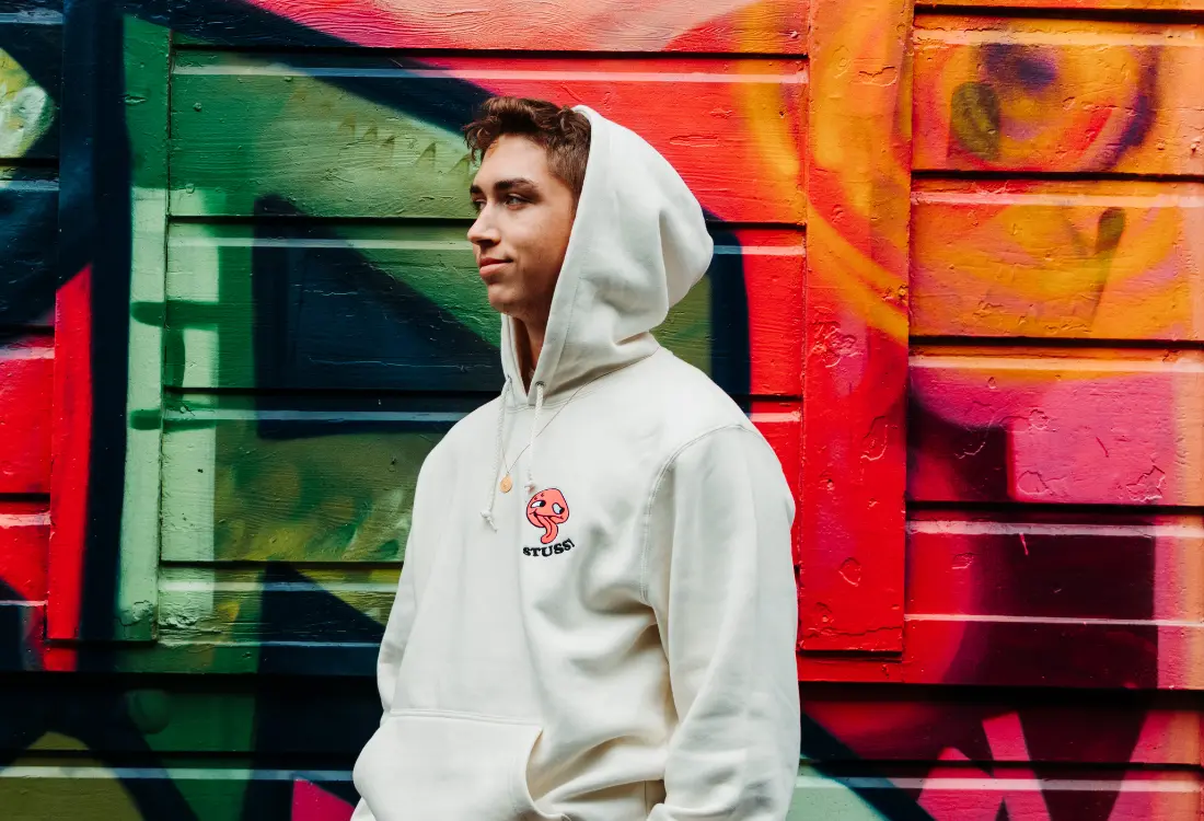 White custom embroidered hoodie made from high quality materials with a small colourful chest logo. Embroidery is a perfect choice for a smaller yet unique design.