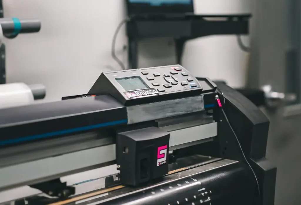 A screen printing press with semi automatic machine produces multiple copies of custom t shirts with vibrant colour.