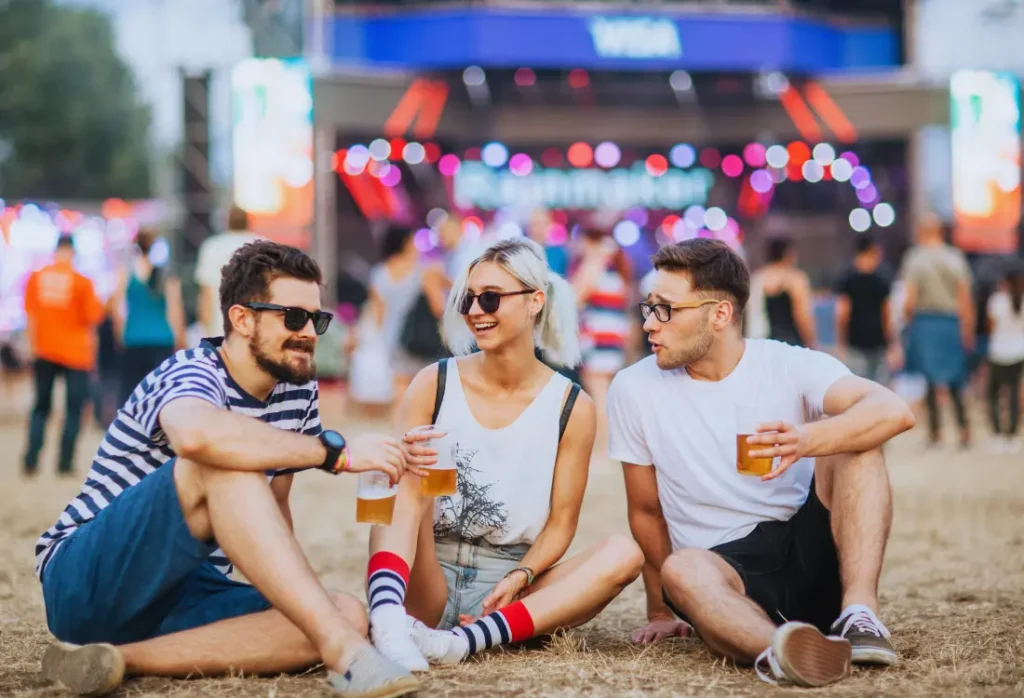 T shirt for festival packed with essentials for music events, featuring neon details, sparkle accents and accessories, perfect for sun, rain, mud, tents, and memorable moments at places like Glastonbury.