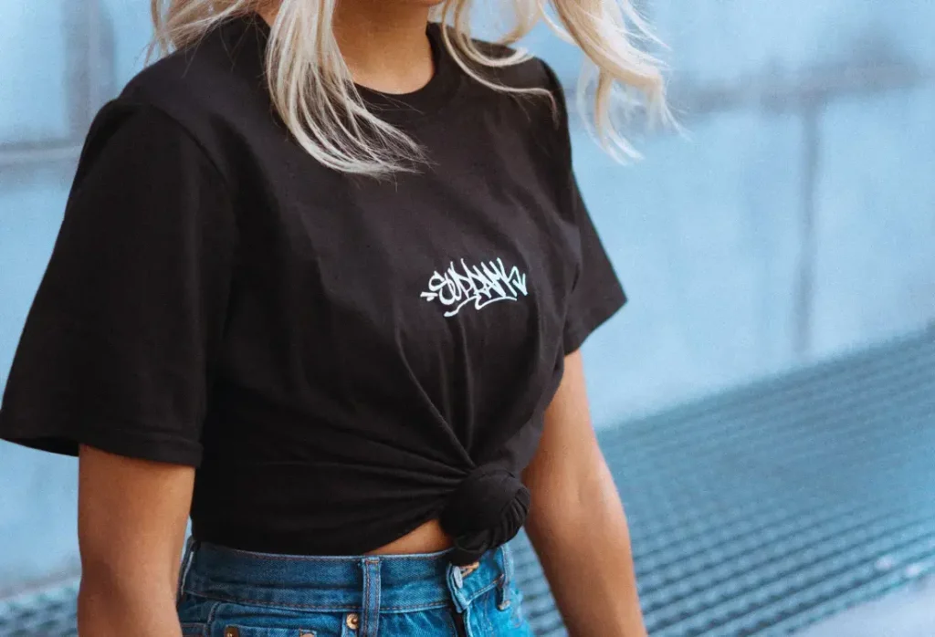 Streetwear t shirt styled for spring fashion with cargo pants and sneakers, showing how people personalise streetwear clothing UK through unique styling, minimal branding, and oversized fits inspired by modern streetwear culture. 