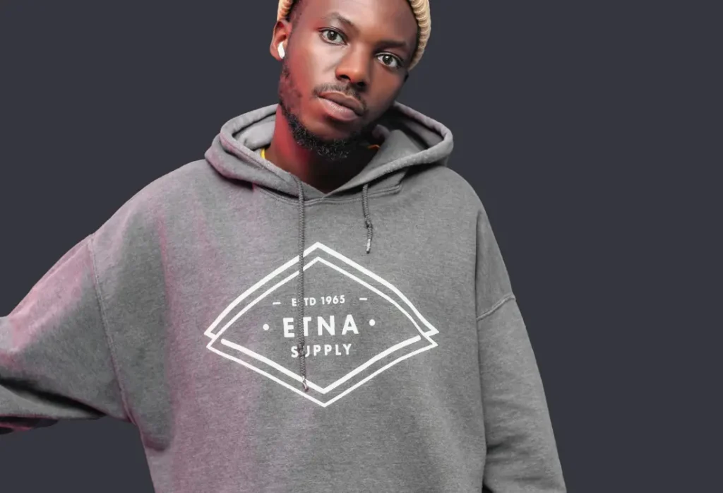 Grey branded hoodie with a printed company logo, showing custom clothing as a premium corporate gift for employees and clients.