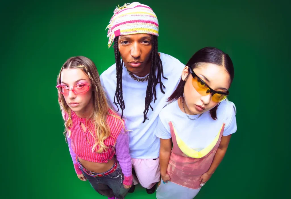 Y2K fashion featuring colourful layered tops, tinted sunglasses, bold accessories and playful early 2000s-inspired styling.