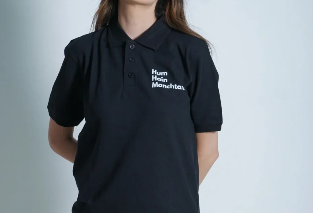 Black polo shirt with a white embroidered company logo, demonstrating smart custom workwear and a professional branded uniform suitable for customer-facing staff.